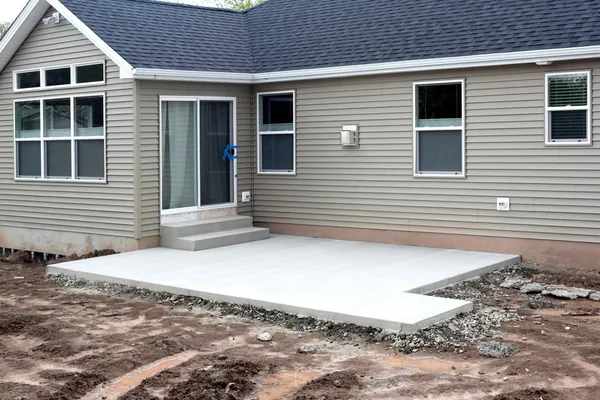 Concrete patio behind a home