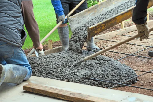 Contractors pouring and spreading concrete