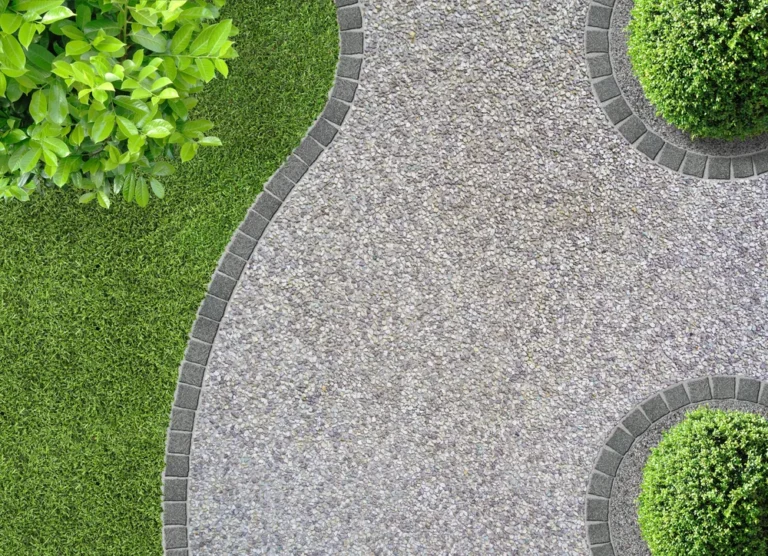 Exposed aggregate walkway through a garden