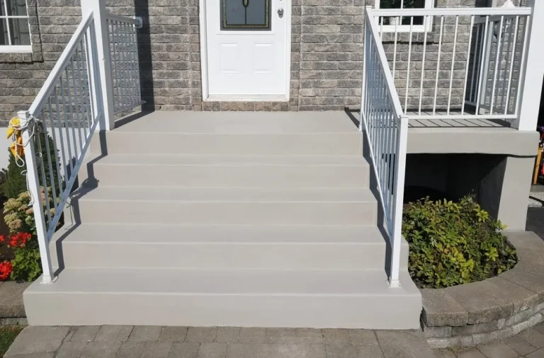 Freshly formed concrete front steps with railings